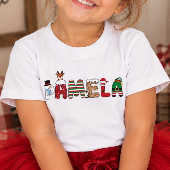 White toddler shirt with a name spelled in Christmas character letters