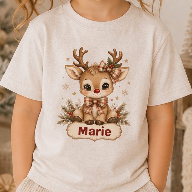 Oatmeal toddler shirt with a baby reindeer in a plaid bow above a custom name banner