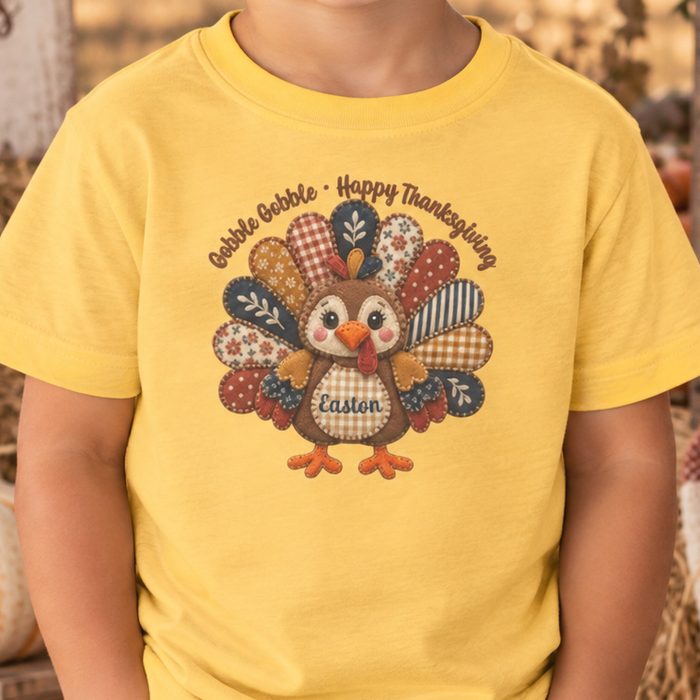 Yellow toddler shirt with a quilted patchwork turkey and a custom name